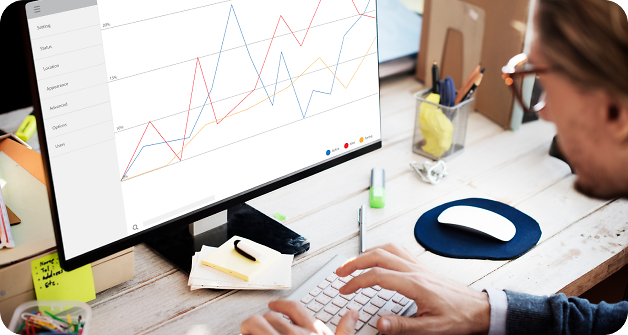 Person looking into graph on computers