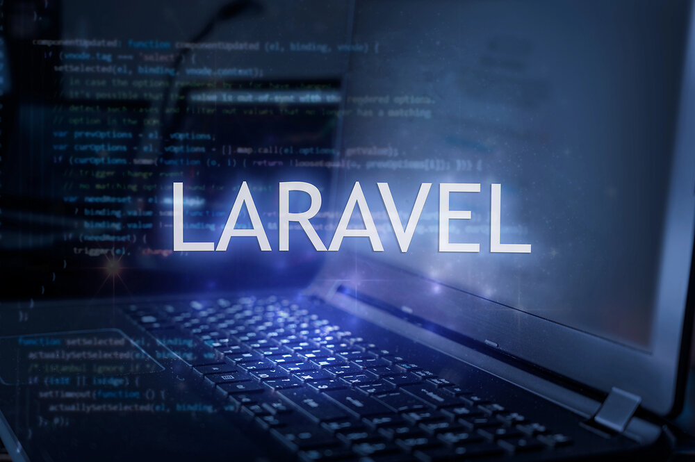 Laravel inscription against laptop and code background. Technology concept.