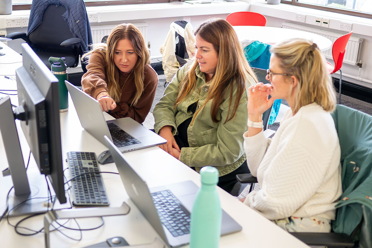 Ladies pointing at laptop