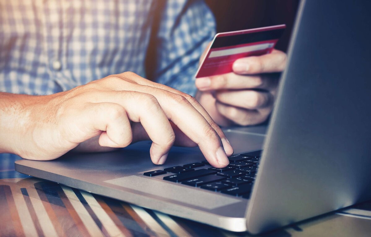 Man inputting card details into laptop