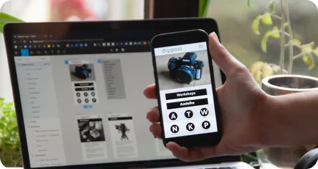 Mobile showing an eccommerce site and a laptop behind