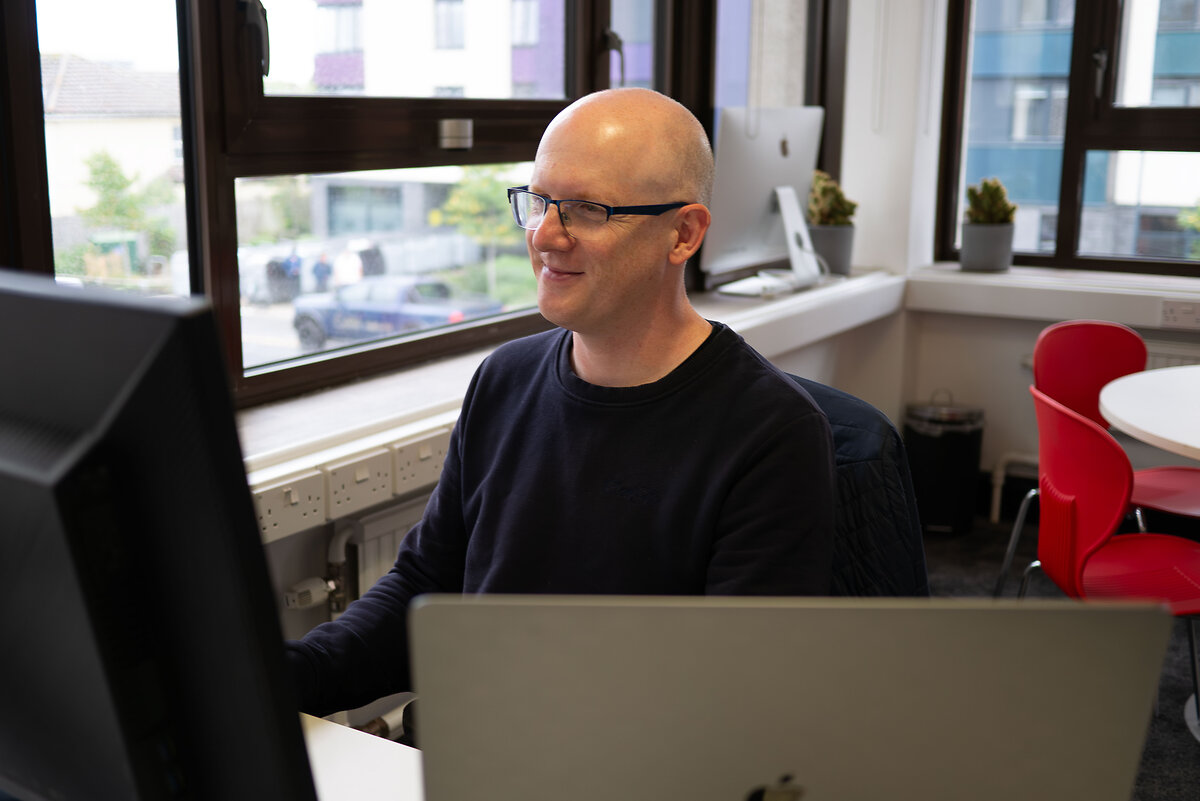 Man using a computer smiling