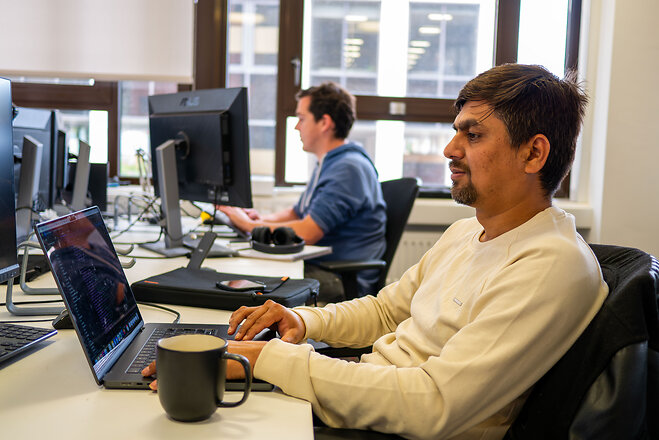 Team looking at laptop