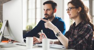 man and woman testing on laptop